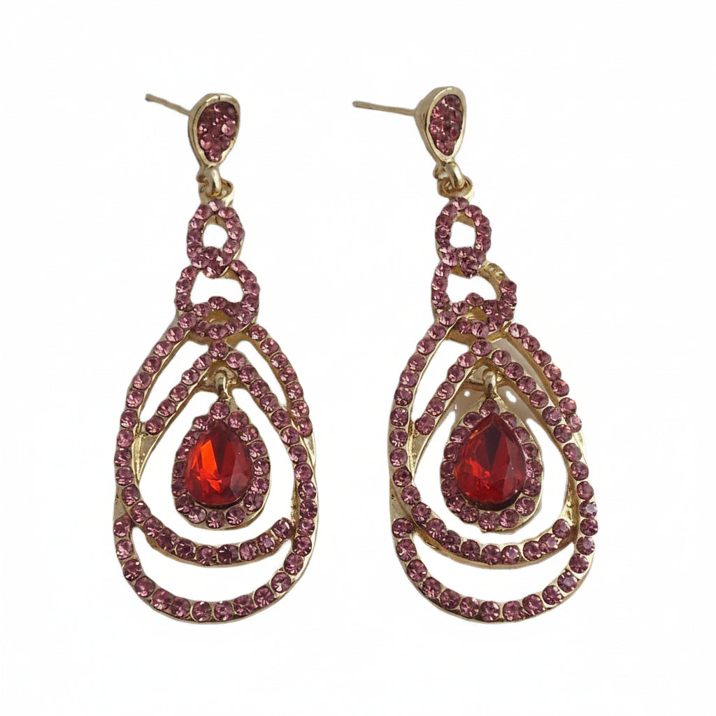 Pair of earrings with red teardrop-shaped gemstones and pink rhinestones on a white background