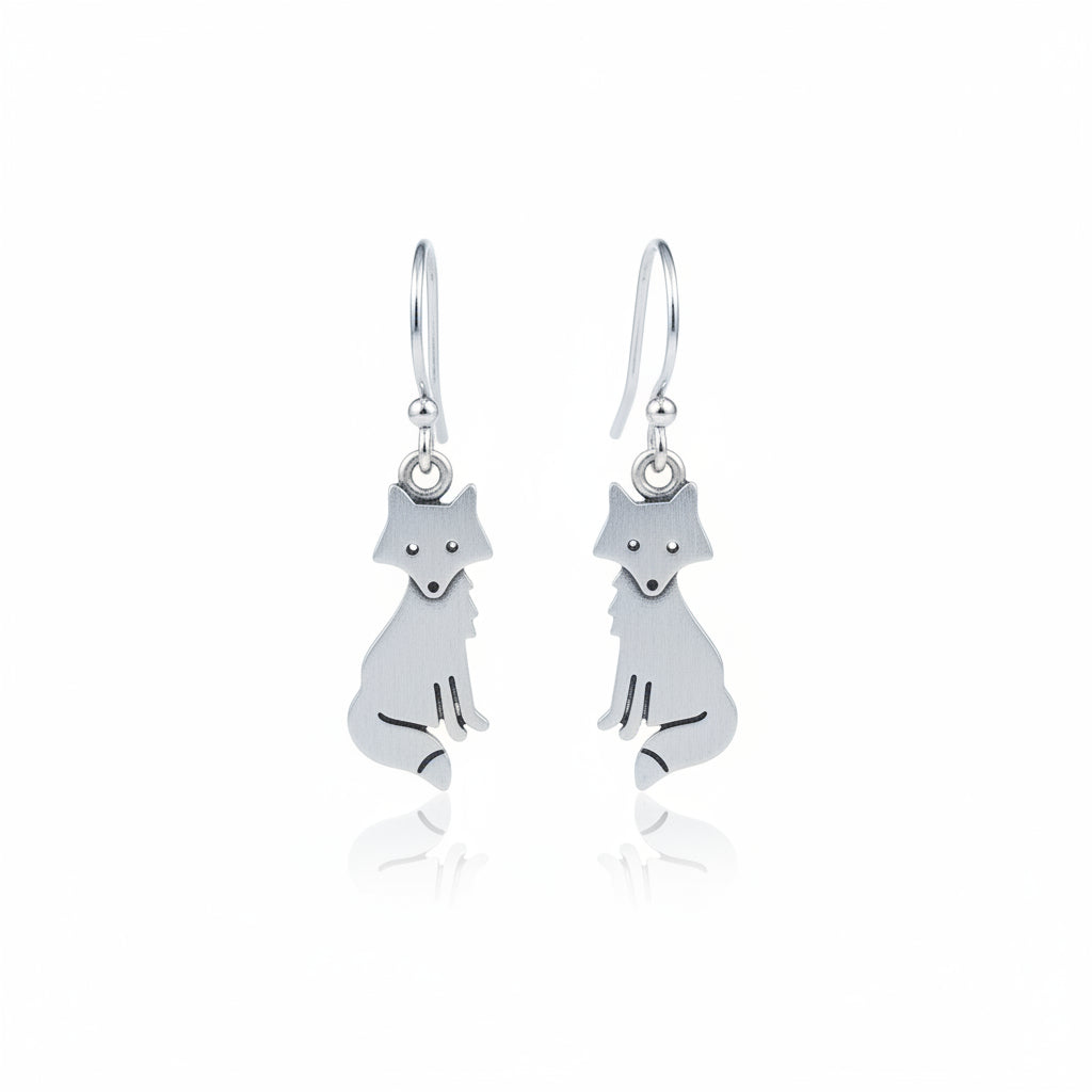Silver fox-shaped earrings on a textured gray surface