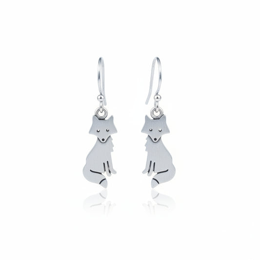 Silver fox-shaped earrings on a textured gray surface