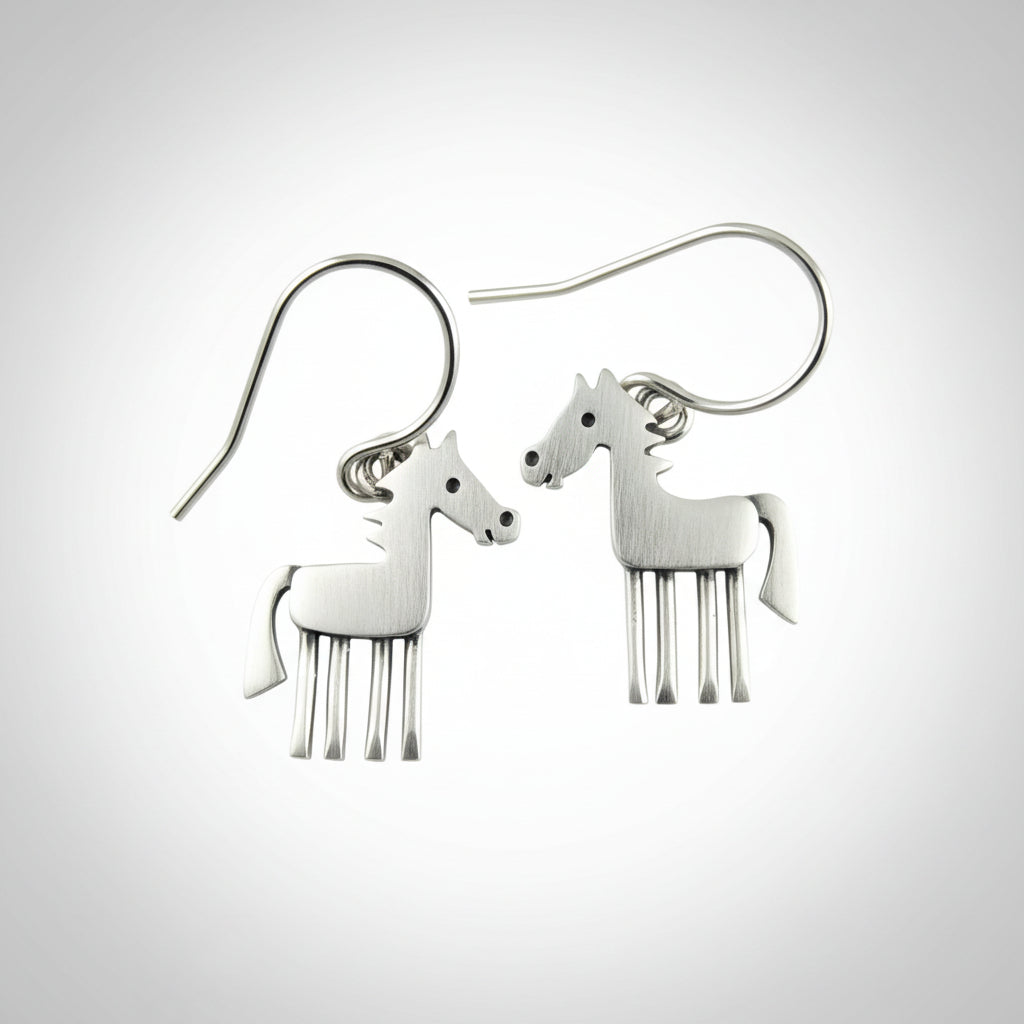 Silver horse-shaped earrings on a brown background