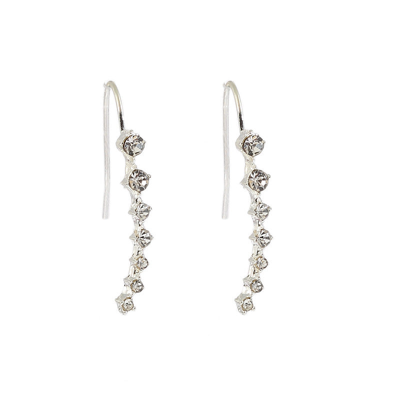 Silver earrings with clear stones on a white background