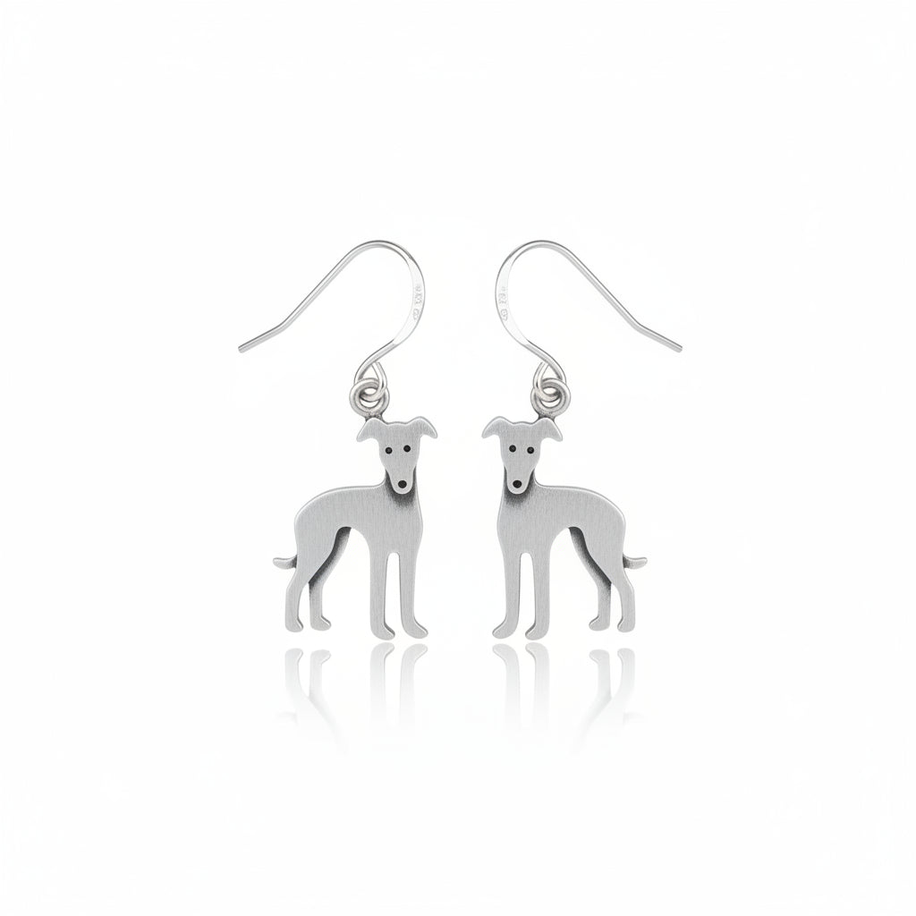 Silver dog-shaped earrings on a wooden background