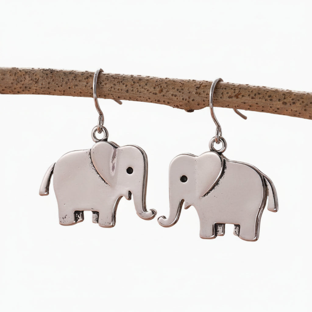 Silver elephant earrings on a brown leather strap against a white background