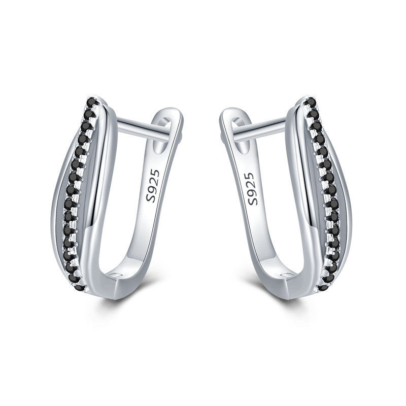 Silver hoop earrings with black stones on a white background