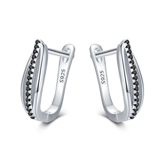 Silver hoop earrings with black stones on a white background